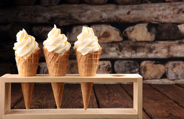Vanilla frozen yogurt or soft ice cream in waffle cone.