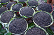 Straw basket full of fresh acai berries to sell at a fair in the city of Belem, Brazil.