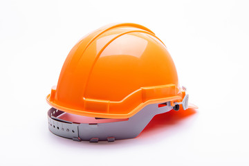 Wall Mural - Orange safety helmet construction on white background.