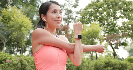 Wall Mural - Sport Woman stretching hand and listen to music