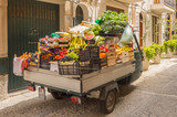 Fototapeta Sawanna - Small truck filled with vegetables and fresh fruits