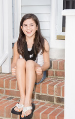 Pretty young girl sitting on steps