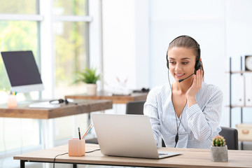 Poster - Female receptionist with headset at desk in office