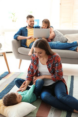 Sticker - Young couple spending time with children at home. Happy family