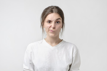 Negative human emotions and feelings. Grumpy young, frowning eyebrows, her look and grimace expressing anger