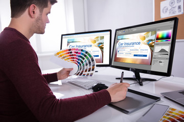 Wall Mural - Designer Working On Multiple Computer Screens