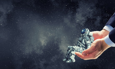 Wall Mural - spaceman on finger. mixed media