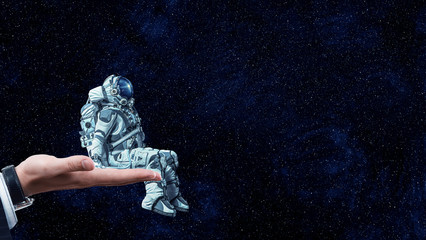 Wall Mural - spaceman on finger. mixed media