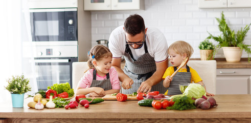 Wall Mural -   father with children preparing vegetable salad