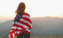 Happy Woman With Flag Of United States Enjoying The Sunset On Nature
