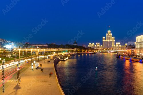 Plakat Miasto Moskwa przy nocą. Moskwa rzeka i budynki w dziejowym centrum Moskwa w pięknej nocy iluminaci.