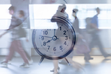 Time management. Blurred business people walking fast on city street against clock. 