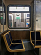 Interior of el train car in Chicago Loop, with view through window of passing train.