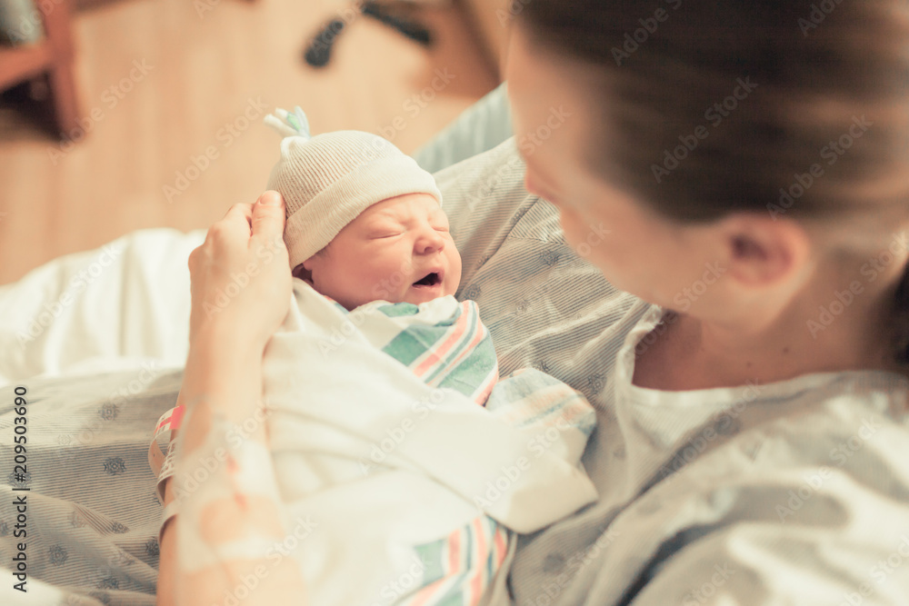 Mother holding new born baby boy in her arms. New life and giving birth concept.  - obrazy, fototapety, plakaty 