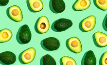 Fresh Avocado Pattern On A Green Background Flat Lay