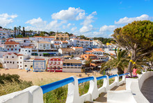 Stairs Leading To The Sandy Beach Surrounded By Typical White Houses,  Carvoeiro, Algarve, Portugal.