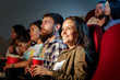 © fotofabrika - Group of friends sitting in movie theater with popcorn and drinks