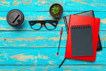 Wall Mural - Cup of coffee with notebook on wooden desk