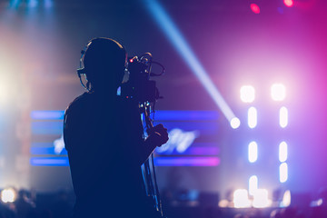 professional cameraman record live concert with beam spot and light performance