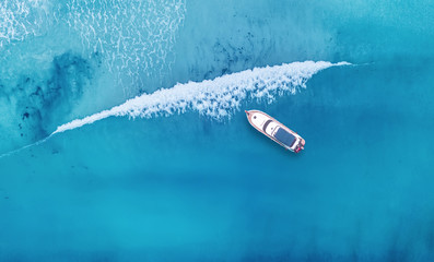 Wall Mural - wave and boat on the beach as a background. beautiful natural background at the summer time from air