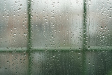 Rain Drops On A Window With Fence