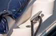 dock cleat on the side of a boat in a small marina, an element of yachting equipment