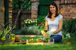 Beautiful mid age woman doing some gardening in her backyard