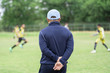 © somchaikhun - Football or socker coach observing kid football match.Healthy sport concept.