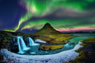 northern light, aurora borealis at kirkjufell in iceland. kirkjufell mountains in winter.