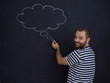 © .shock - young future father thinking in front of black chalkboard