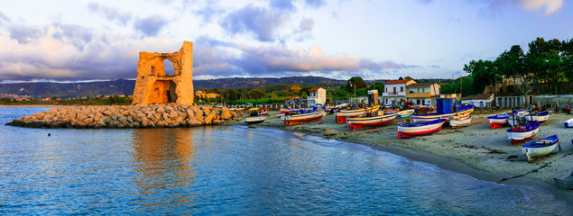 Canvas Print - Traditional fishing village Briatico with colorful boats and old saracen tower. Calabria, Italy