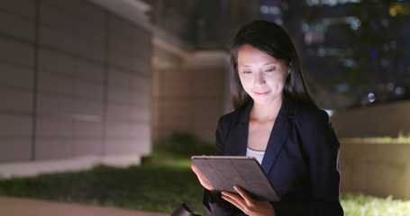 Poster - Business woman use of digital tablet at night