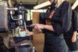 © hedgehog94 - Female barista making espresso coffee.