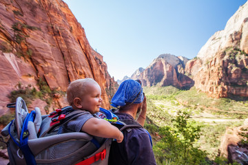 Wall Mural - A man with his baby boy are trekking in Zion national park, Utah, USA
