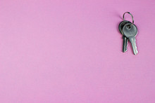 Two Metal Keys On Purple Background. Empty Space For Text And Design.