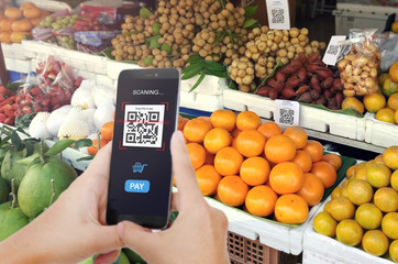 Wall Mural - Qr code payment, E wallet , cashless technology concept. Man scaning tag Fresh Fruit in Market accepted generate digital pay without money.