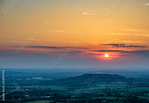 Fotografie, Obraz Sunset viewed from Crickley Hill looking towards Gloucester and the hills in the distance