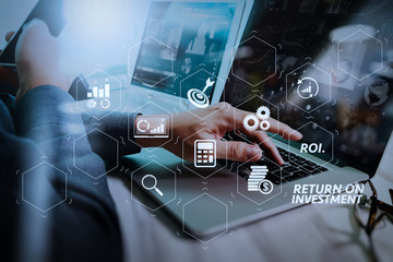 Poster - businessman hand working on laptop computer with digital layer business strategy and social media diagram on marble desk