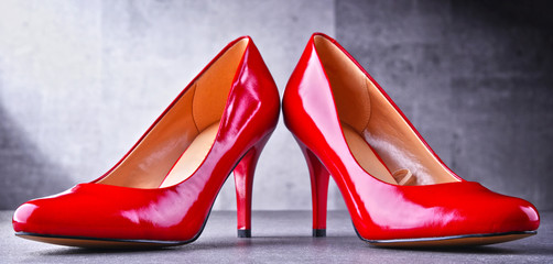 Composition with a pair of red high heel shoes