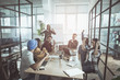 © Yakobchuk Olena - Super team. Cheerful young pleasant colleagues are sitting around table while working on new business strategy. They are raising hands up while expressing gladness. Successful startup project concept
