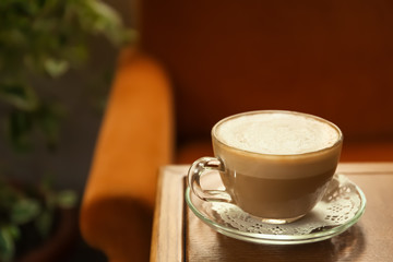 Wall Mural - Cup of delicious aromatic coffee on table