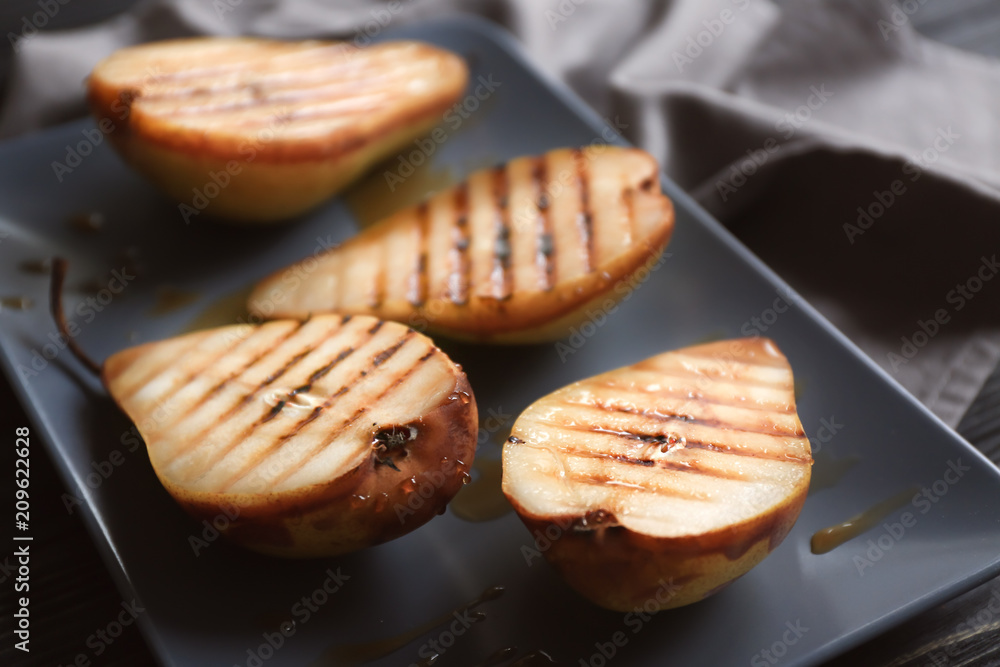Tasty baked pears on plate