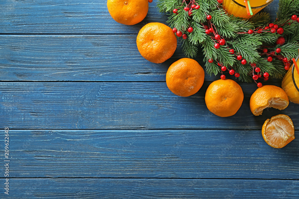 Christmas composition with fresh mandarins on wooden table