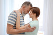 © Africa Studio - Happy mature couple dancing at home