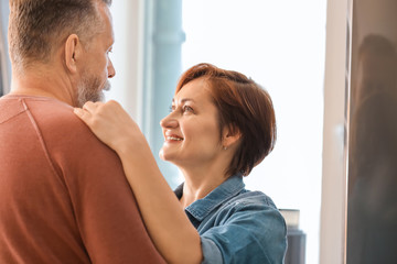 Wall Mural - Happy mature couple dancing at home