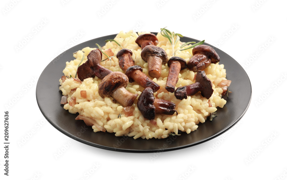 Plate with tasty risotto and mushrooms on white background