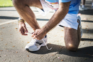 Sticker - Man tying the shoelace on his shoe