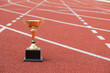 © weerapat1003 - A golden trophy on running track / Competition for success concept