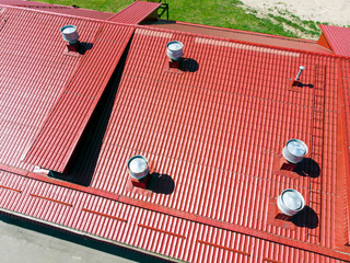 Wall Mural - new red metal warehouse roof with installed pipes of ventilation systems