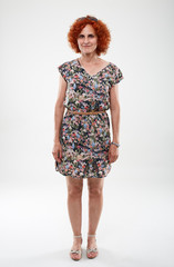 Curly haired woman in floral dress